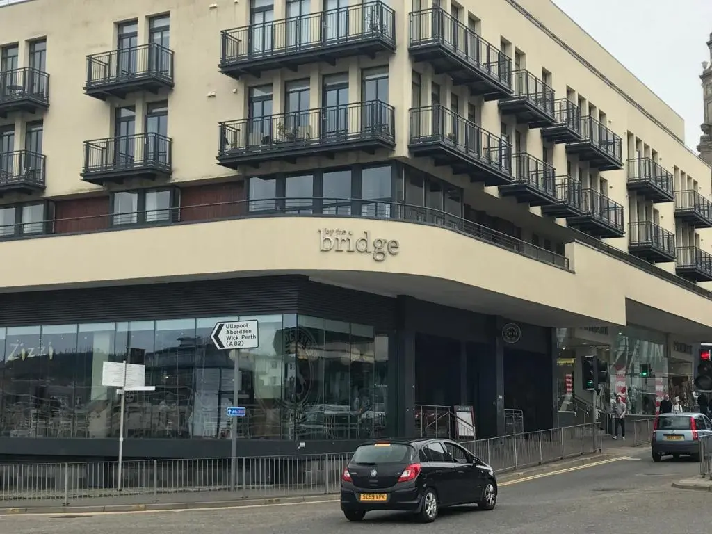 a black car parked in front of a building at Apartment 306 By the Bridge in Inverness