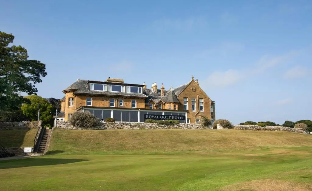 a large house on a hill with a green yard at Royal Golf Hotel, by Highland Coast Hotels in Dornoch