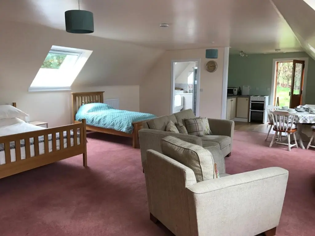 a living room with a couch and a bed at Whitehill in Finzean