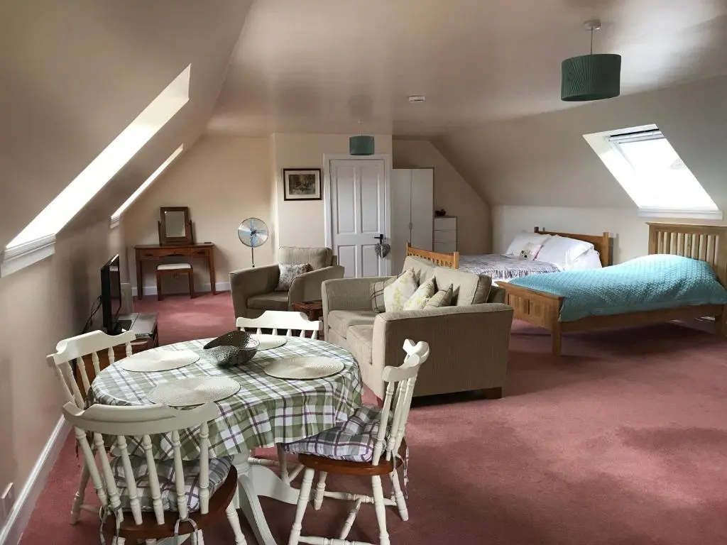 a living room with a couch and a table at Whitehill in Finzean