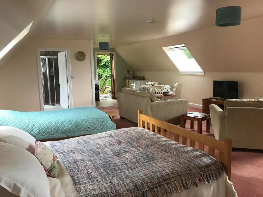 a bedroom with two beds and a living room at Whitehill in Finzean