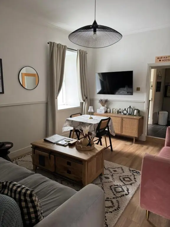 a living room with a couch and a table at Harbour quay in Wick