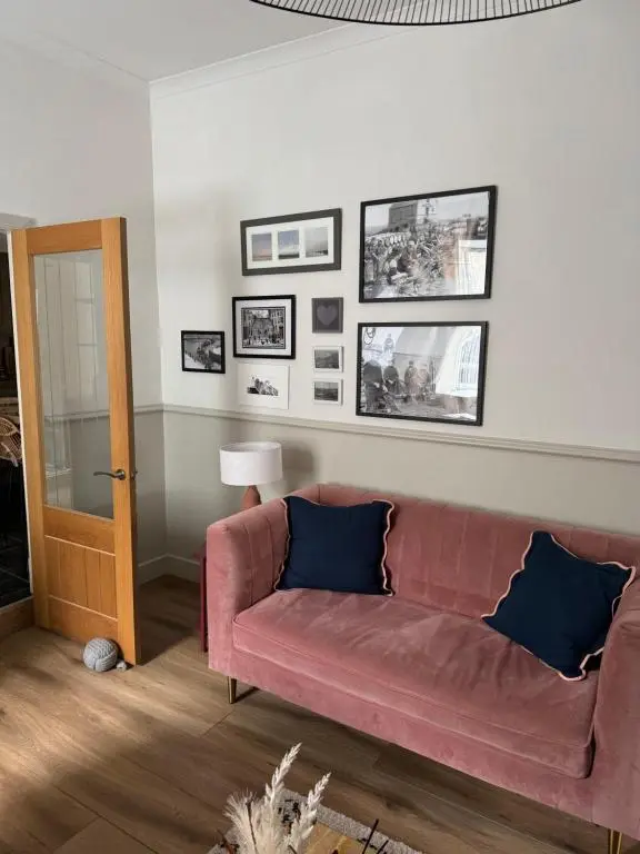 a living room with a couch and pictures on the wall at Harbour quay in Wick