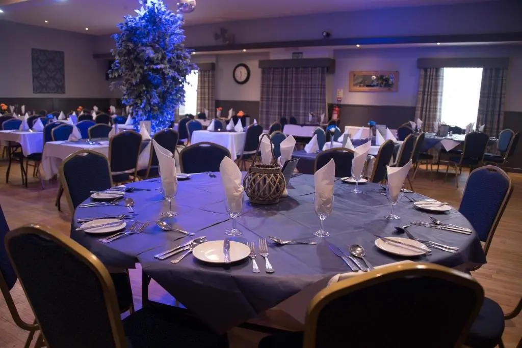 a table set up for a banquet in a banquet hall at The Davron Hotel in Fraserburgh