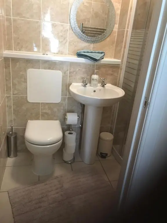 a bathroom with a toilet and a sink at River Ness Apartments in Inverness