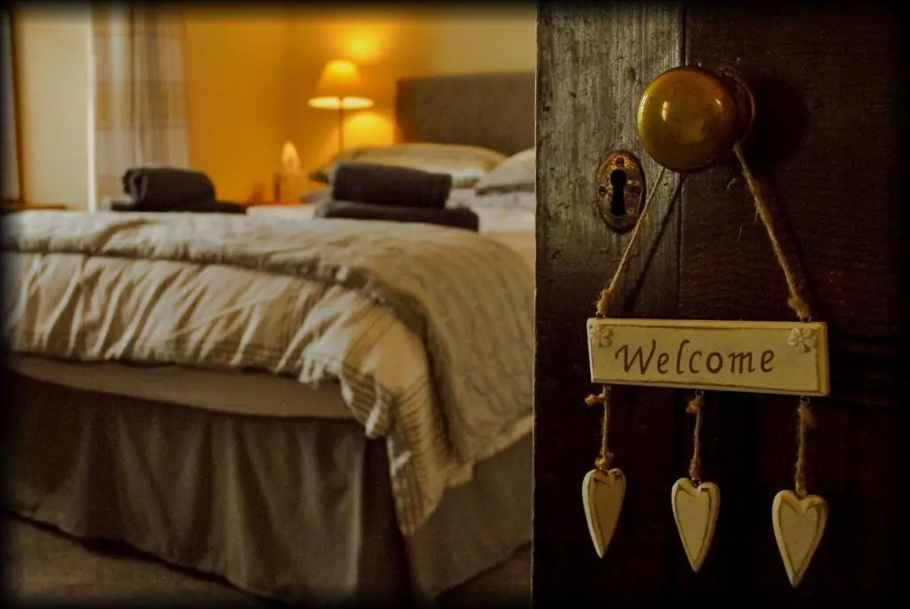 a bedroom with a bed with a welcome sign on it at Kylelachin in Dingwall