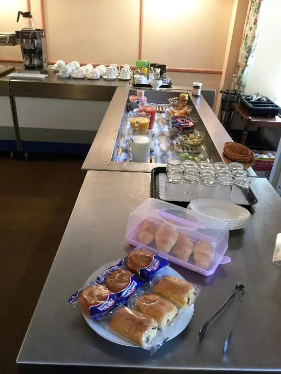 a table with a bunch of pastries on it at Belgrave Arms Hotel in Helmsdale
