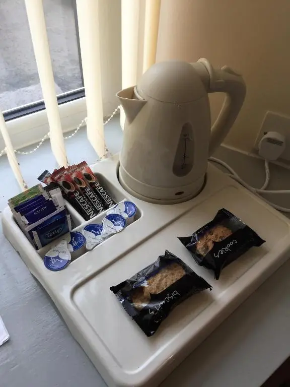 a white tray with food and a tea kettle at Belgrave Arms Hotel in Helmsdale