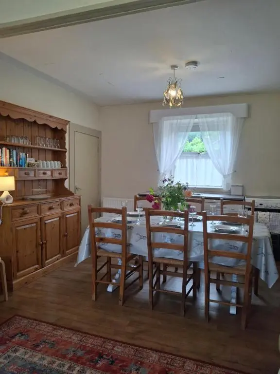 a dining room with a table and chairs and a window at Aberlour Cottages - Bolthole & Retreat in Aberlour