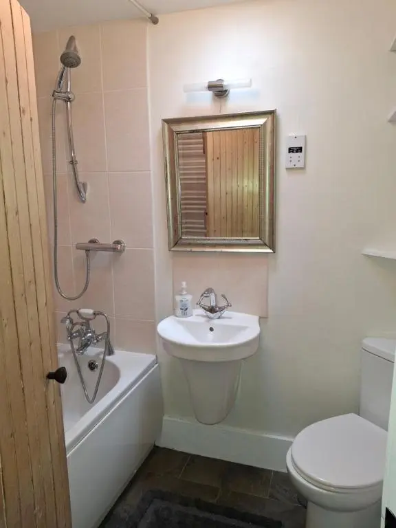 a bathroom with a sink and a tub and a toilet at Aberlour Cottages - Bolthole & Retreat in Aberlour