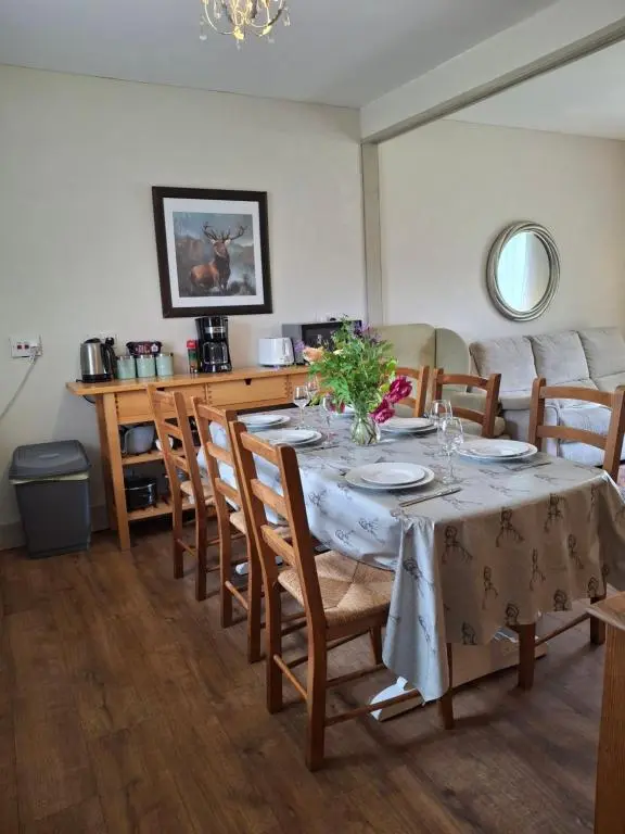 a dining room with a table and some chairs at Aberlour Cottages - Bolthole & Retreat in Aberlour