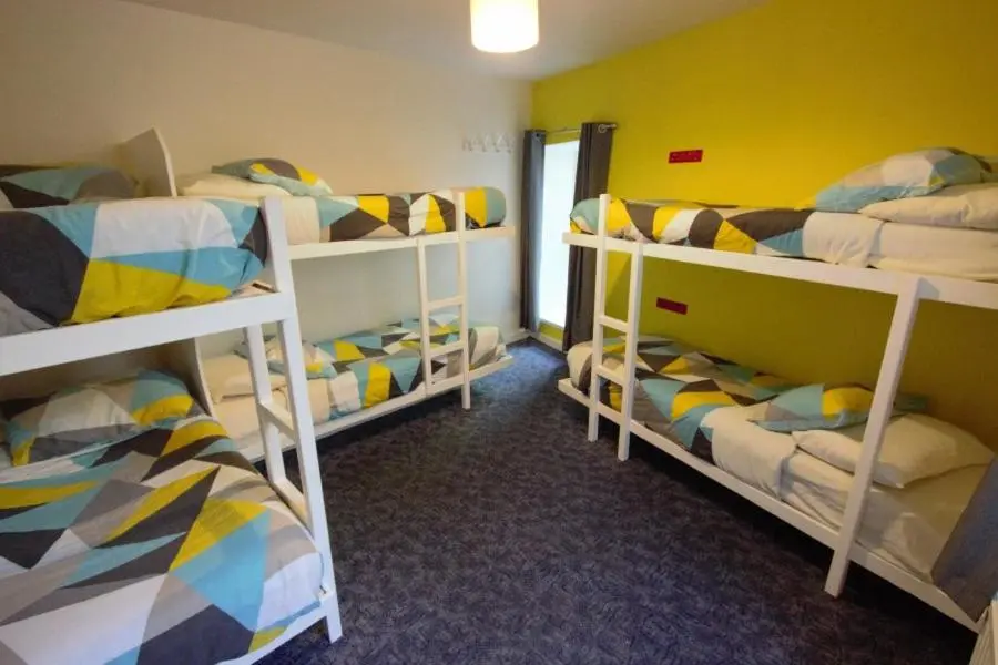 a room with three bunk beds in a room at Inverness Student Hotel in Inverness