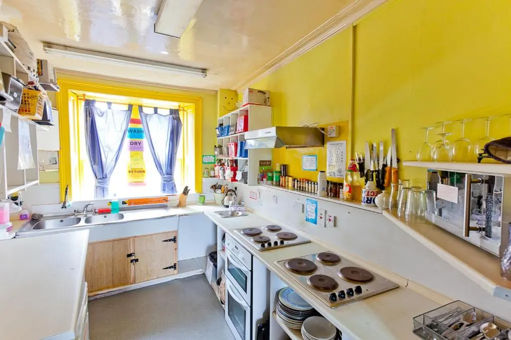 a kitchen with a sink and a stove top oven at Inverness Student Hotel in Inverness