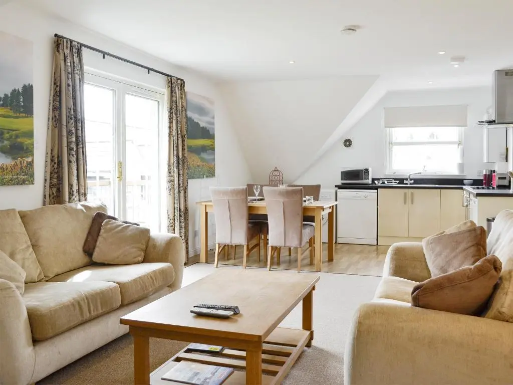a living room with a couch and a table at 22 Queens Court in Inchmarlo