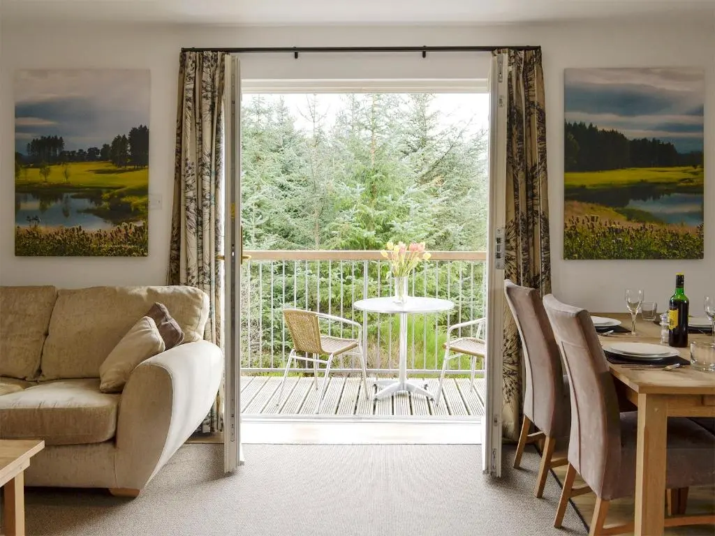 a living room with a couch and a table at 22 Queens Court in Inchmarlo