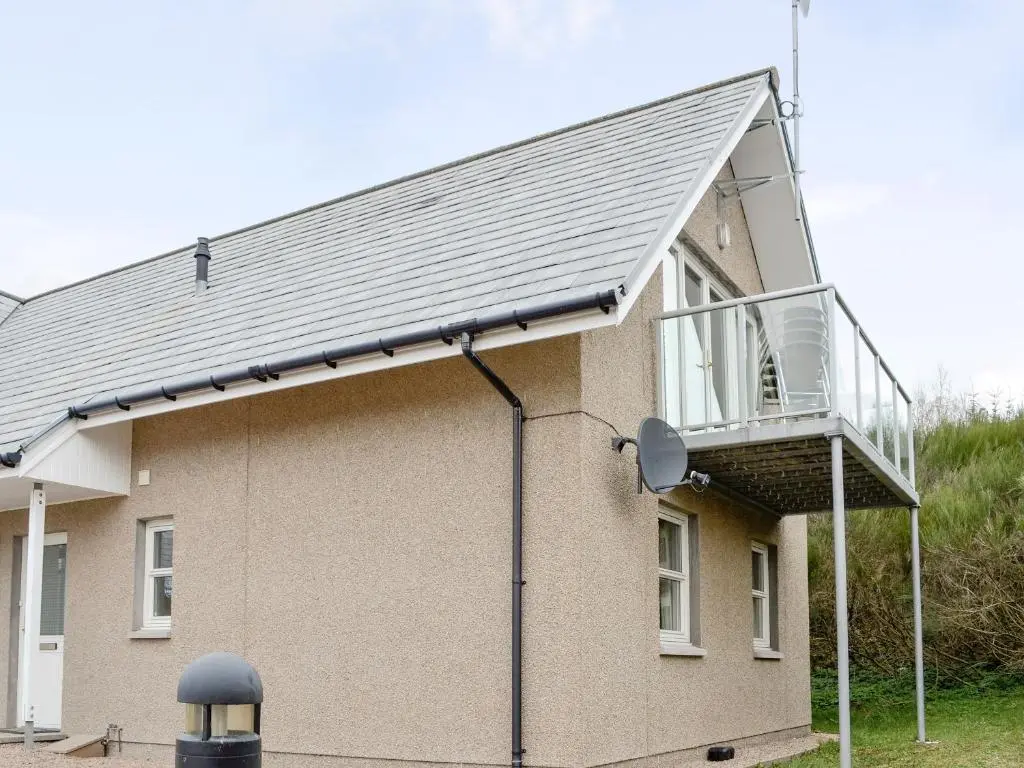 a house with a balcony on the side of it at 32 Queens Court in Inchmarlo
