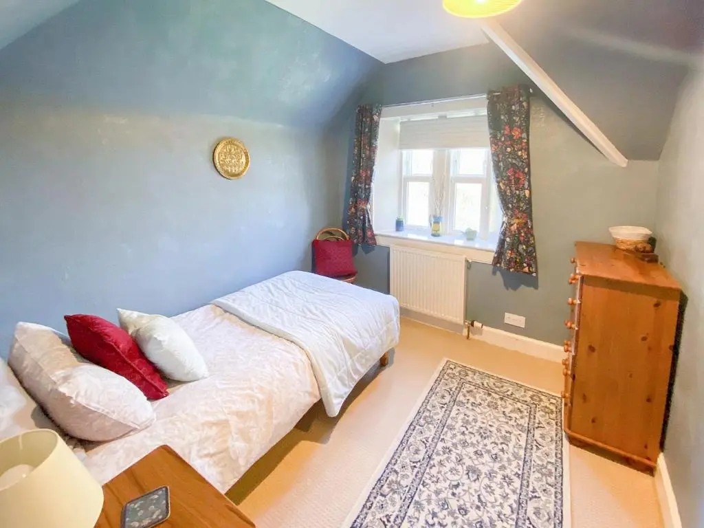 a bedroom with a bed and a window at The Gate Lodge in Latheron
