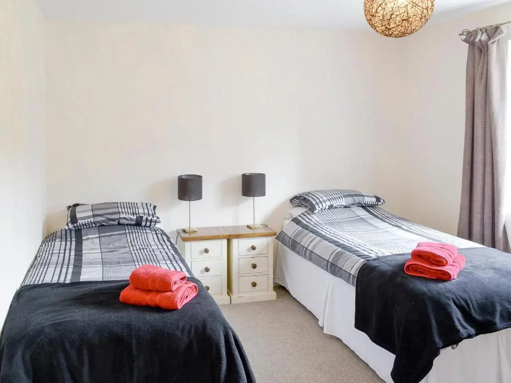 two beds sitting next to each other in a bedroom at Keeper's House in Glenrossal