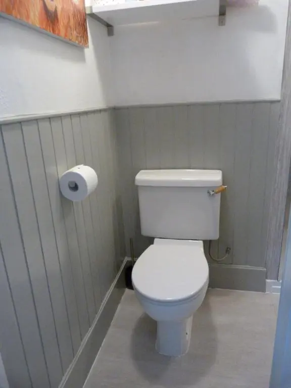 a bathroom with a toilet and a roll of toilet paper at Wee Ness Cottage in Inverness