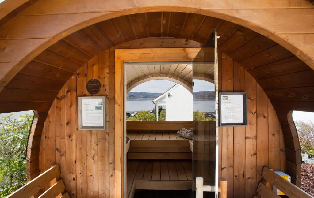 an outside view of a wooden cabin with an arched doorway at Fishermans in Inverness