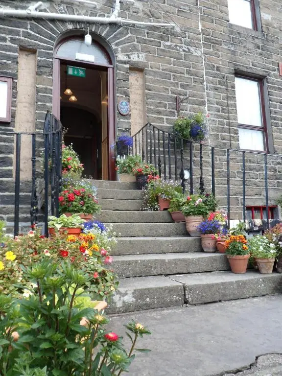 a group of potted plants on stairs in front of a building at Nethercliffe Hotel in Wick