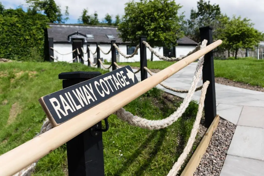 a street sign on a fence in a yard at The Old Manse of Blair, Boutique Hotel & Michelin Restaurant in Blair Atholl