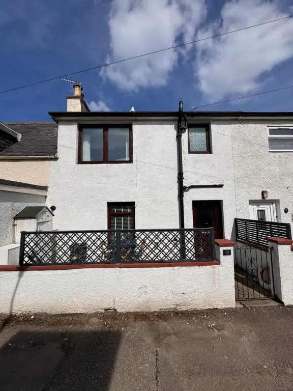 a large white house with a large balcony at Seaforth Cottage -Dog friendly, Historical Fishertown, central location in Nairn