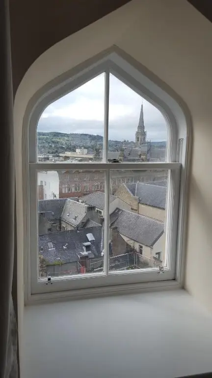 an open window with a view of a city at View Cottage in Inverness