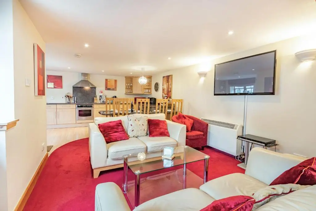 a living room with two couches and a tv at Dunstaffnage Cottage in Grantown on Spey