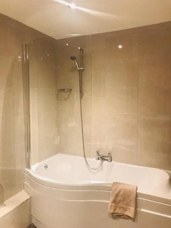 a bathroom with a bath tub and a shower at Blervie House in Forres