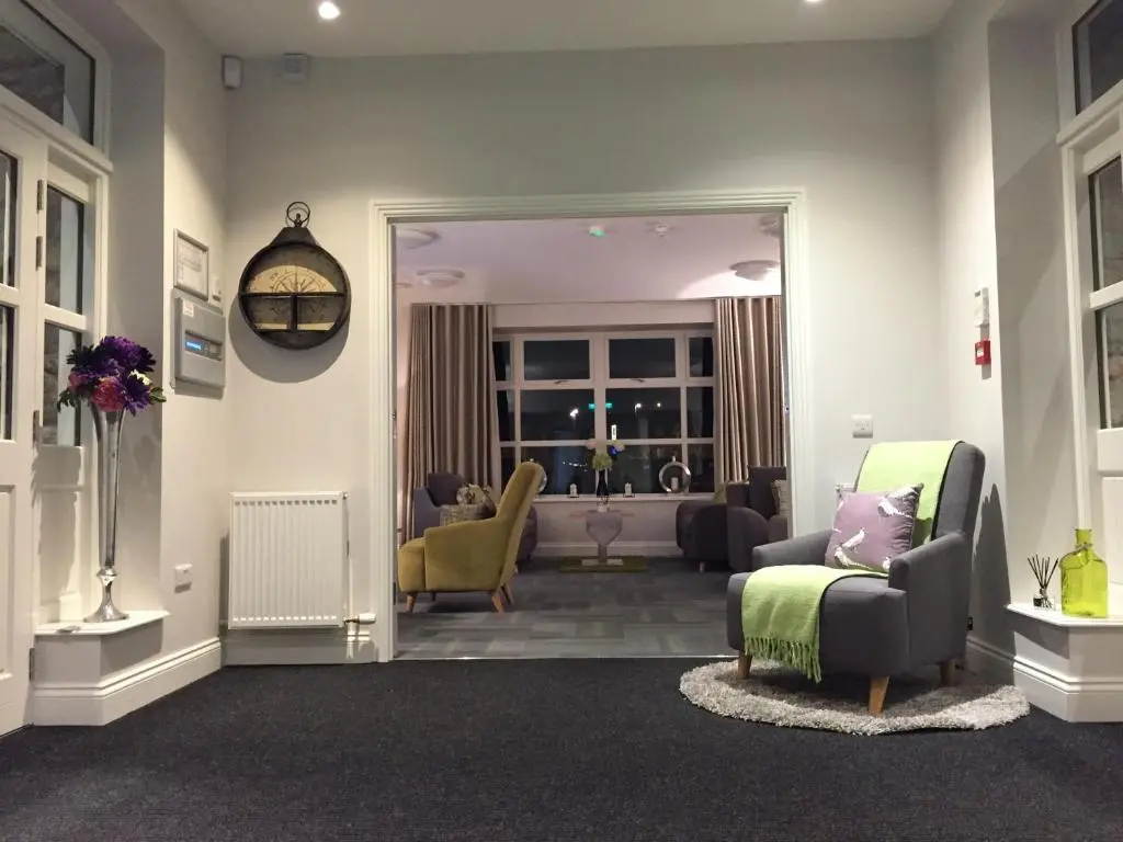 a living room with chairs and a couch and a living room at The Sidings Inverurie in Inverurie