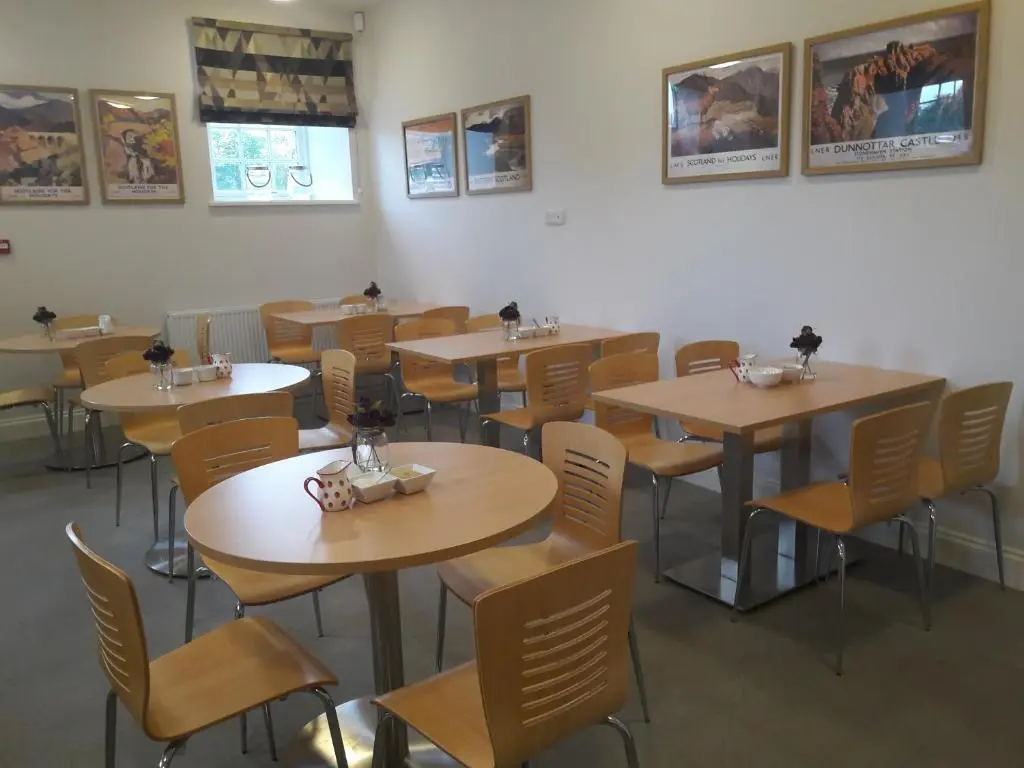 a restaurant with tables and chairs in a room at The Sidings Inverurie in Inverurie