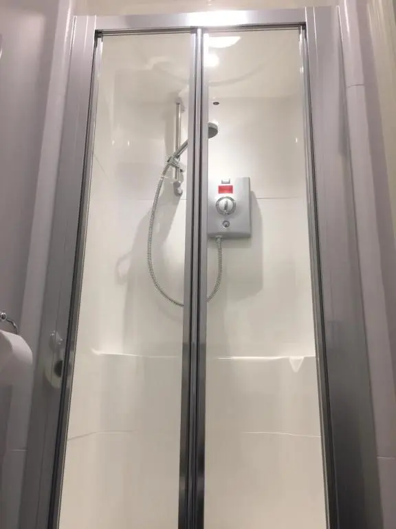 a shower with a glass door in a bathroom at The Sidings Inverurie in Inverurie