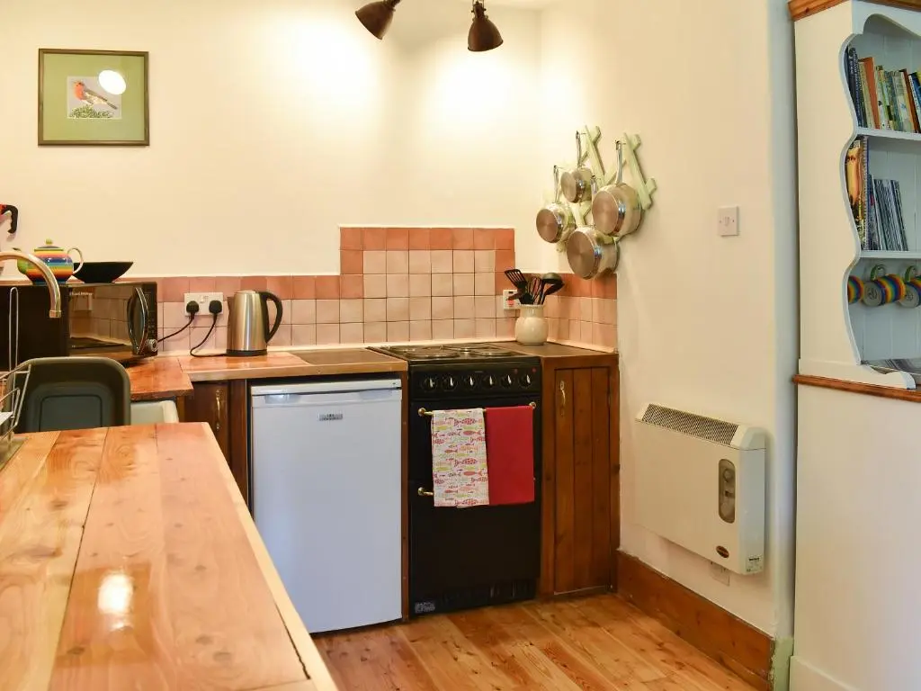 a kitchen with a black and white dishwasher at St Orans in Rafford