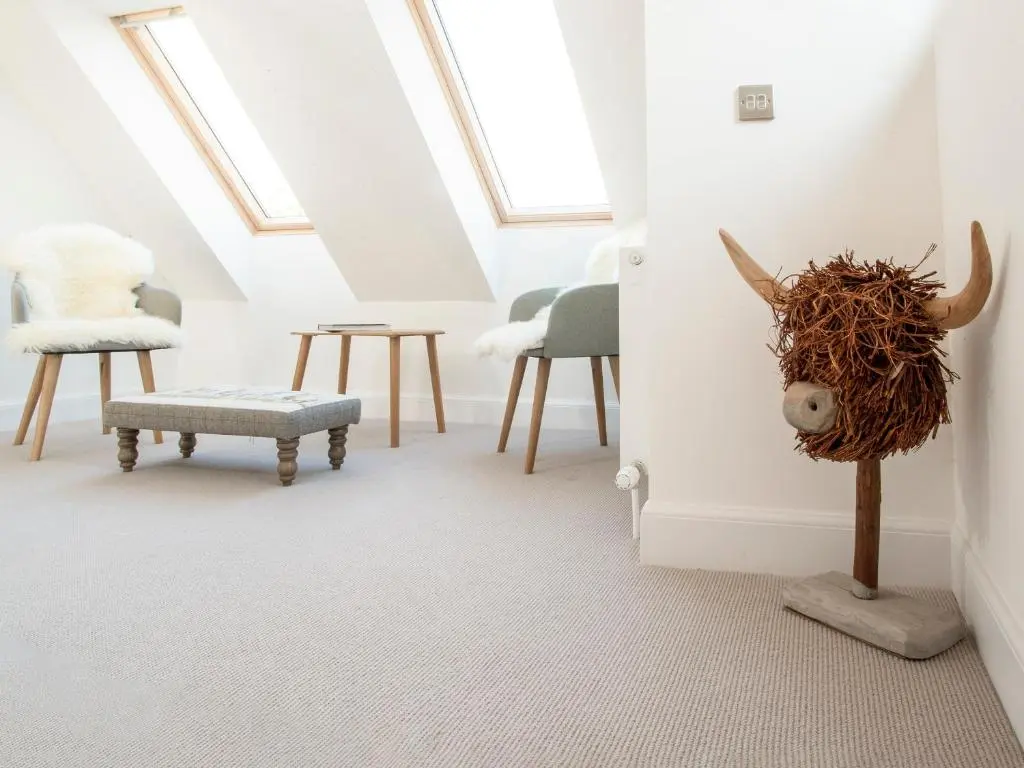 a room with chairs and a head on the wall at Strathspey Lodge in Duthil