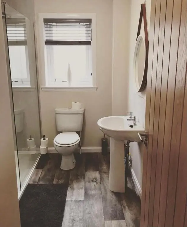 a bathroom with a toilet and a sink at Malva - Modern 2 Bedroom Bungalow in Wick Sleeps 4 with private parking - NC500 Route in Wick