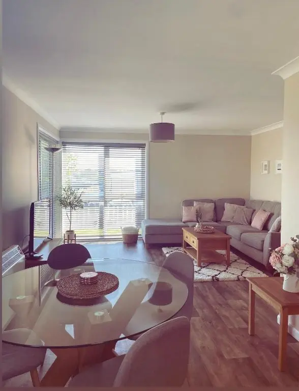 a living room with a couch and a table at Malva - Modern 2 Bedroom Bungalow in Wick Sleeps 4 with private parking - NC500 Route in Wick