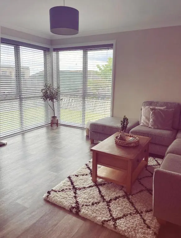 a living room with a couch and a coffee table at Malva - Modern 2 Bedroom Bungalow in Wick Sleeps 4 with private parking - NC500 Route in Wick