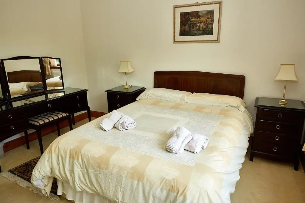 a bedroom with a bed with towels on it at Rowans Inverness in Inverness