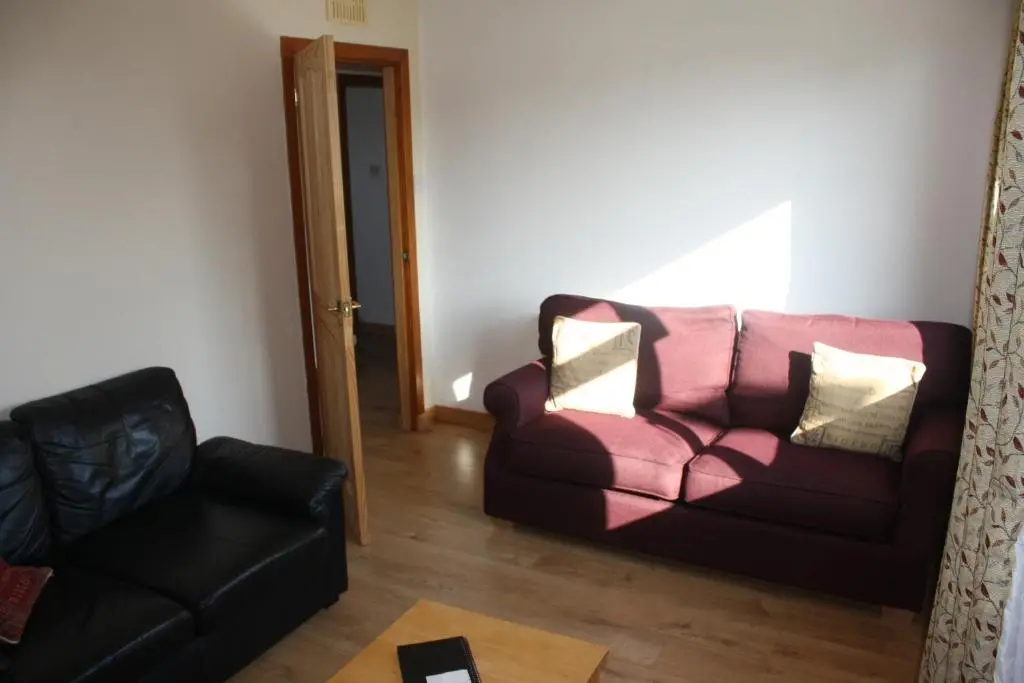 a living room with a couch and a chair at Inver bay apartment in Tain