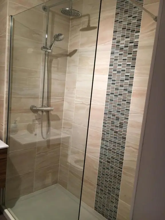 a shower with a glass door in a bathroom at Christiesholidayhomes in Aviemore