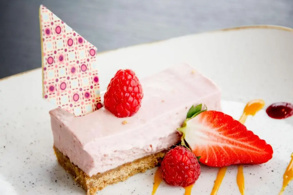 a piece of cake with strawberries on a plate at The Knowes Hotel & Restaurant in Macduff