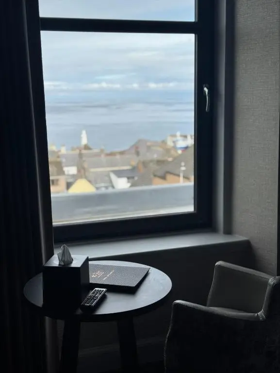 a room with a window and a table with a laptop at The Knowes Hotel & Restaurant in Macduff