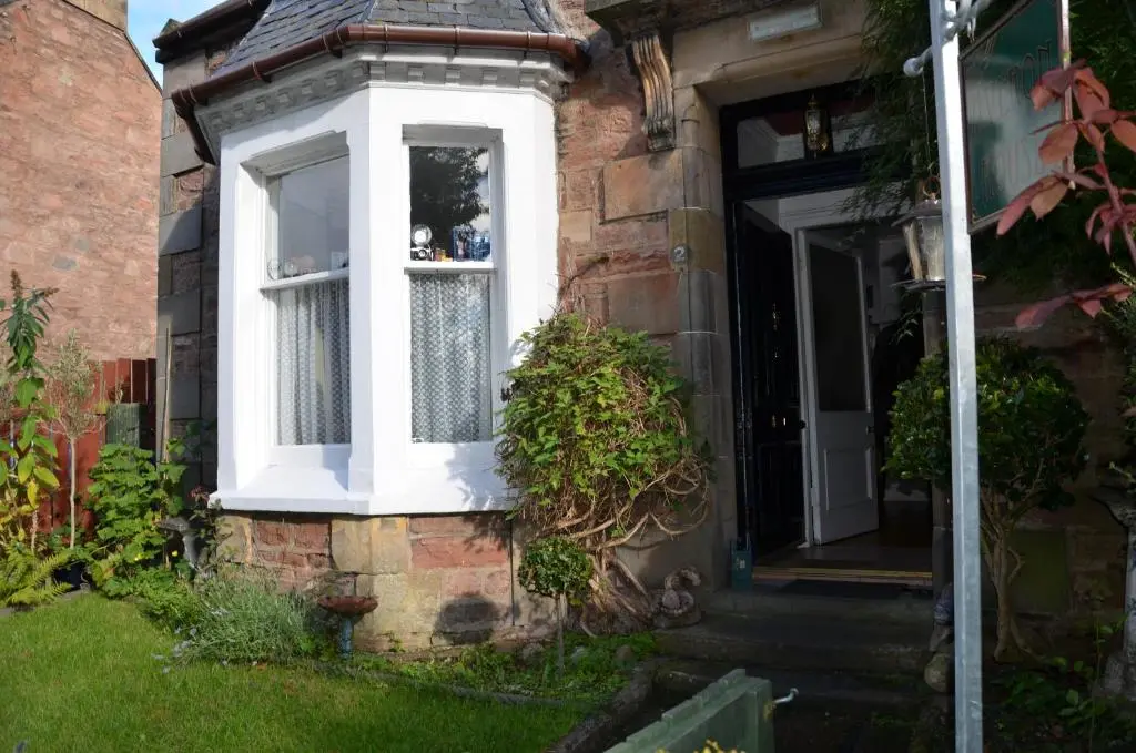 a white window on the side of a house at Averon House in Inverness