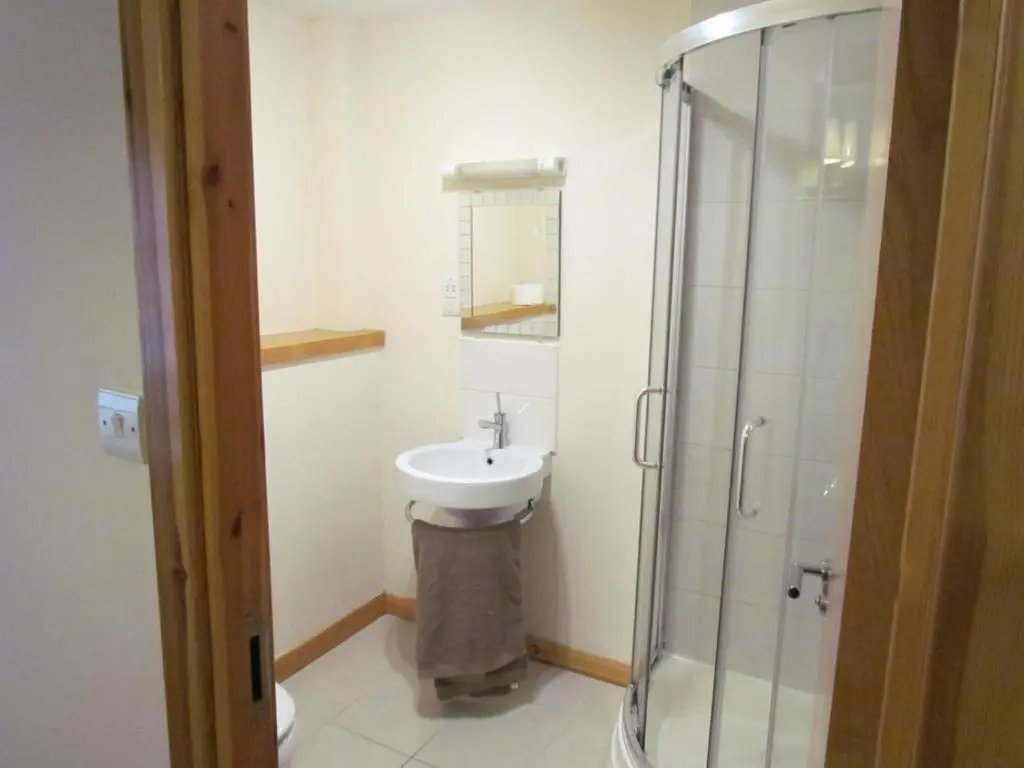 a bathroom with a sink and a shower at Farraline Court in Inverness