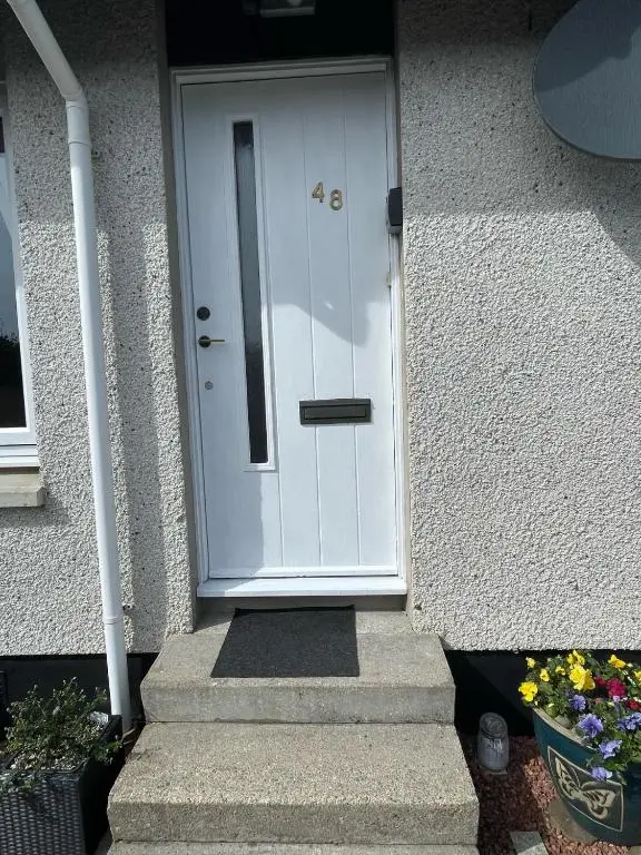 a white front door of a house with stairs at Hillside View, Inverness in Inverness