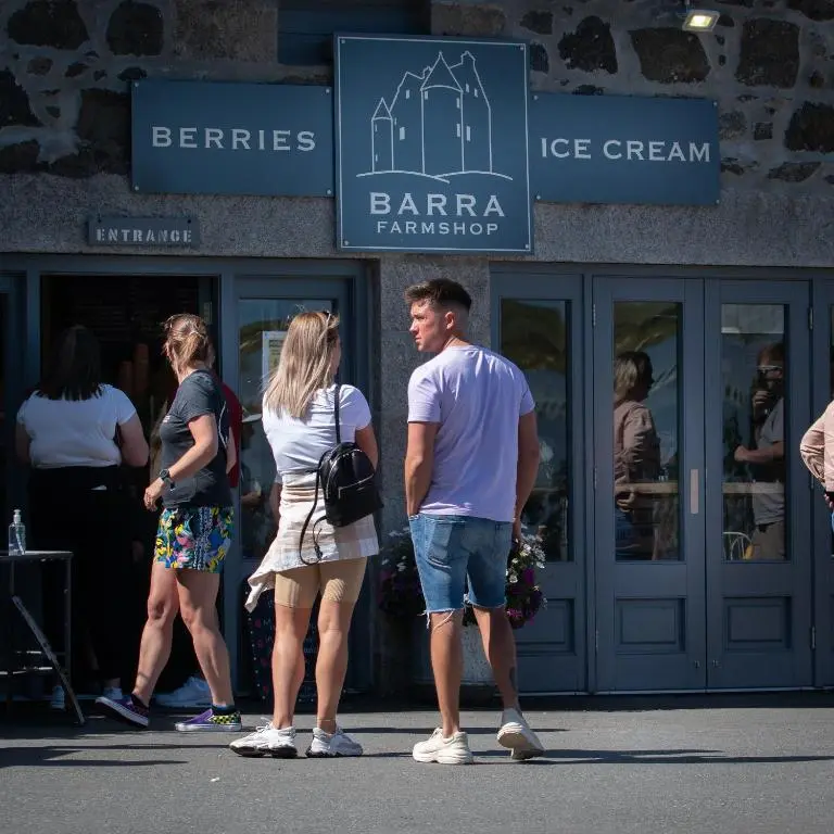 a group of people standing in front of a store at The Lodges @ Barra Castle in Inverurie