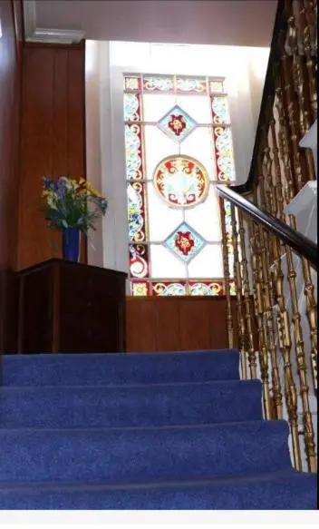 a staircase with a stained glass window in a building at Elgin Guest House in Elgin