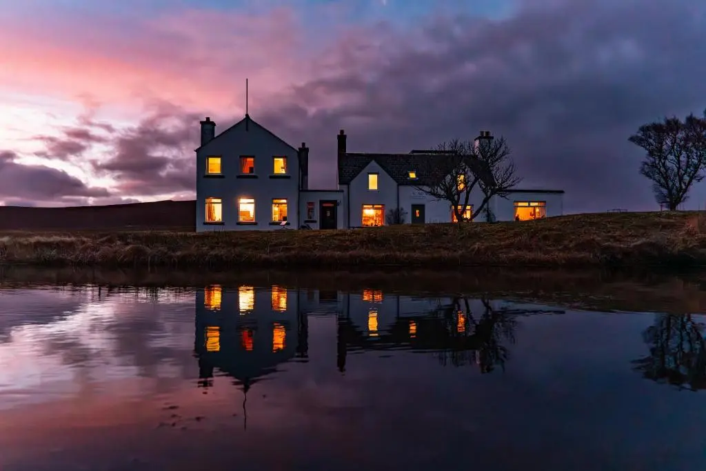 a house on the shore of a body of water at Garvault House in Kinbrace