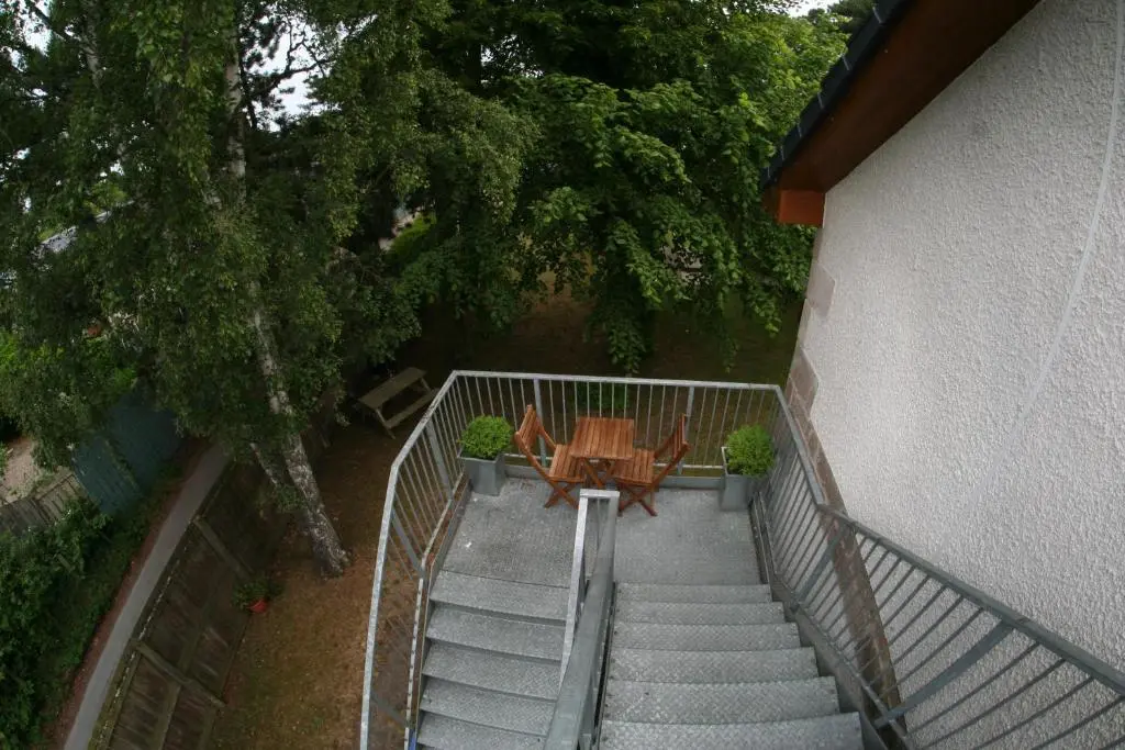 an overhead view of a staircase with a table and a tree at Mulberry in Nairn